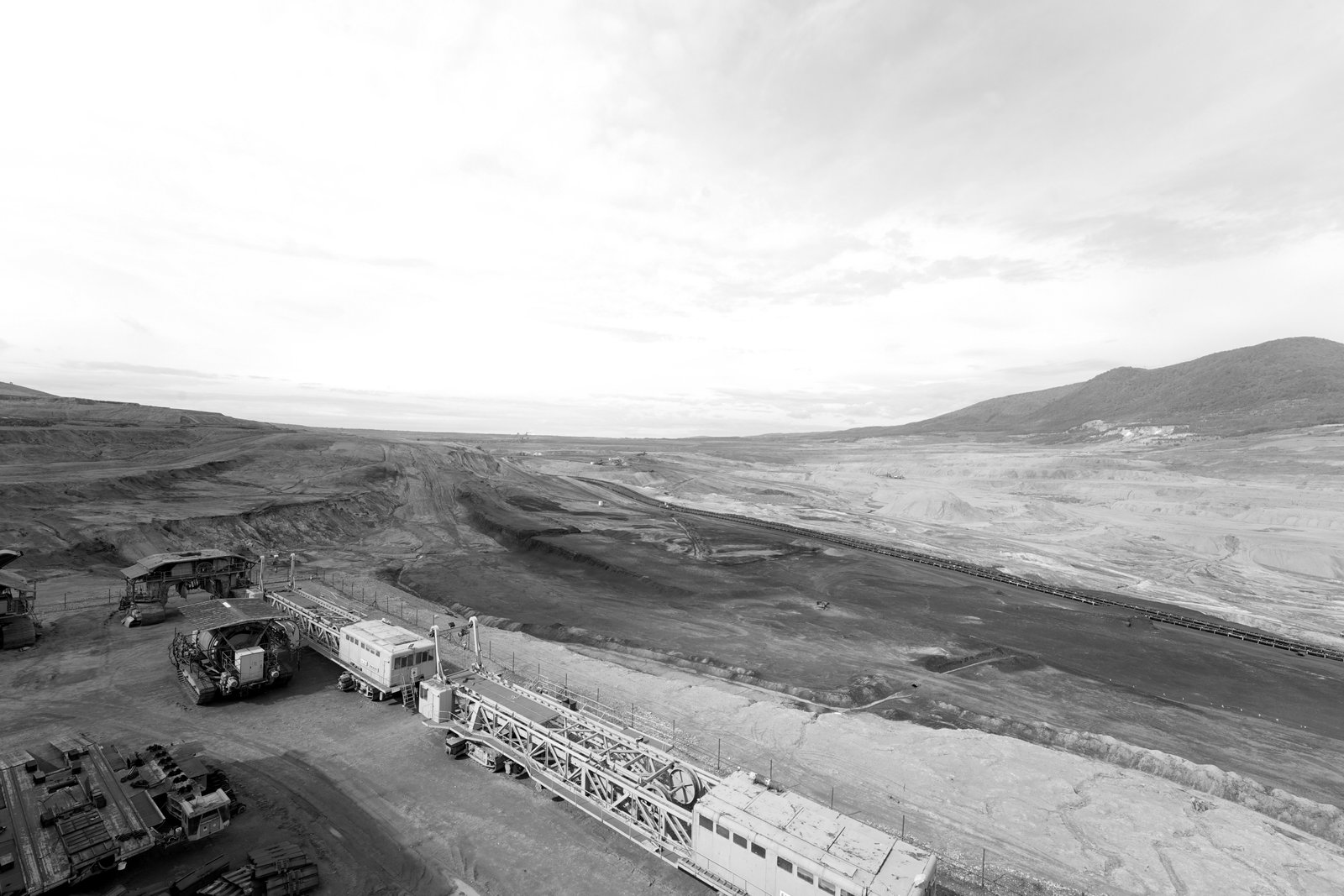 Photo overlooking a quarry with some mining machinery in the foreground